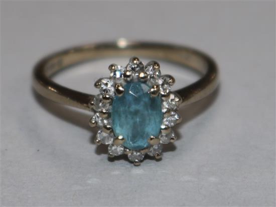 638An 18ct gold blue topaz and diamond cluster ring, size L.